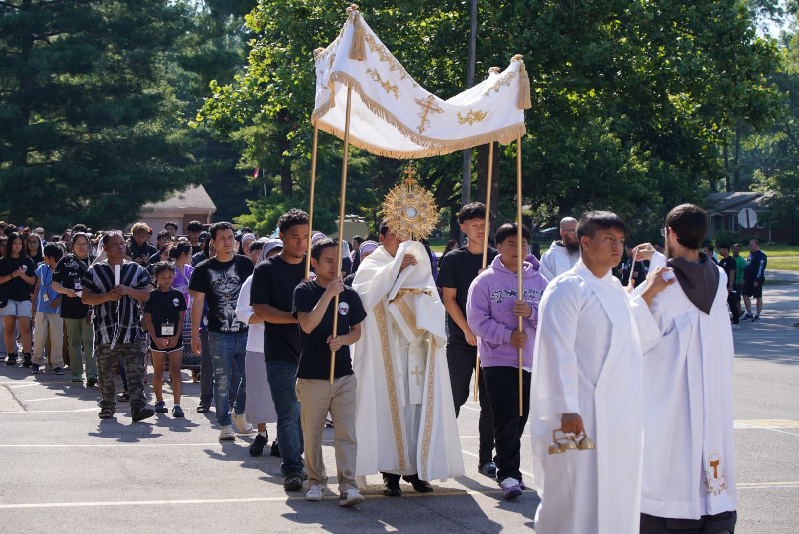 KACC community in a Eucharistic procession led by the priest