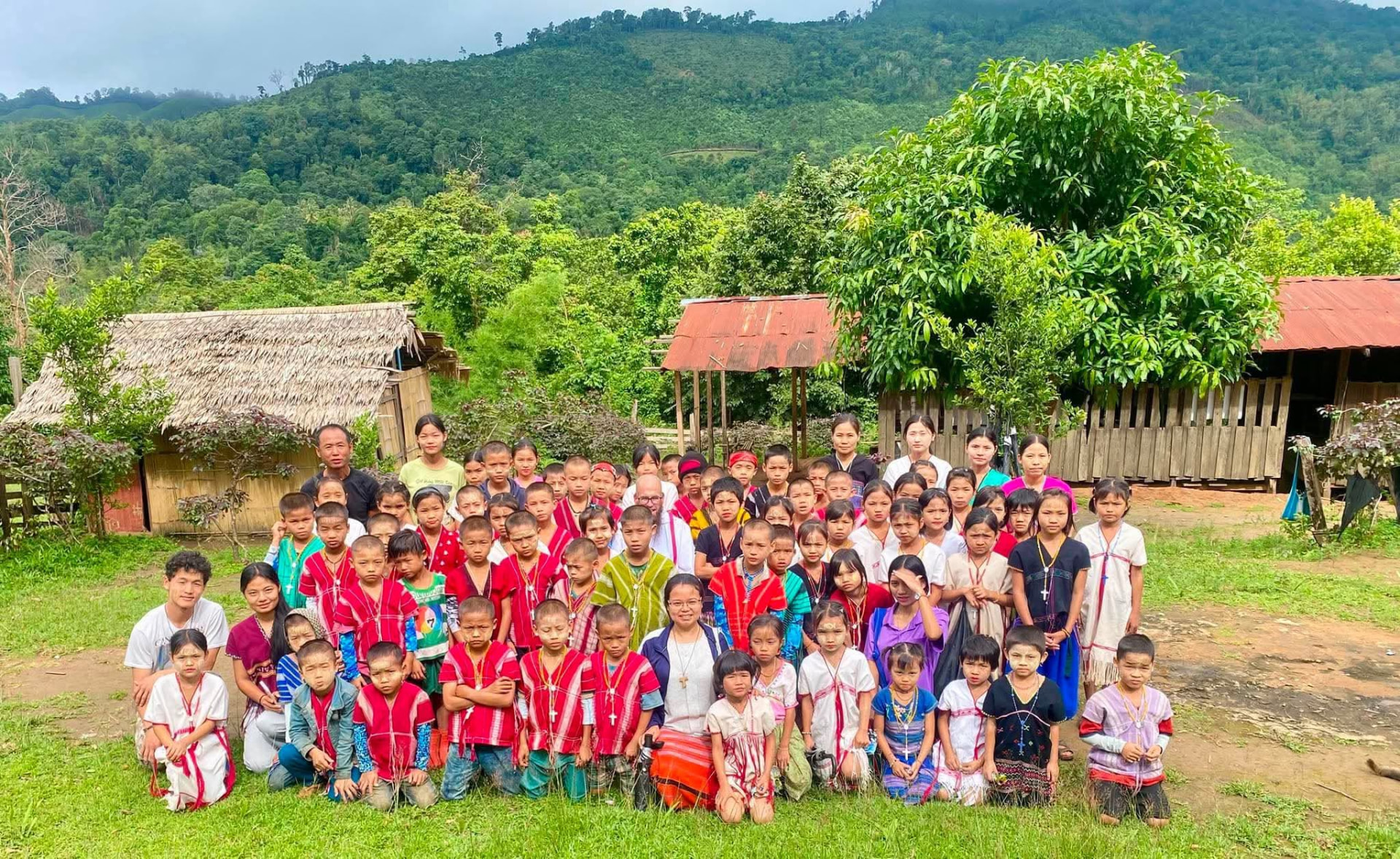 St. Joseph mission community members and children gathered with a priest